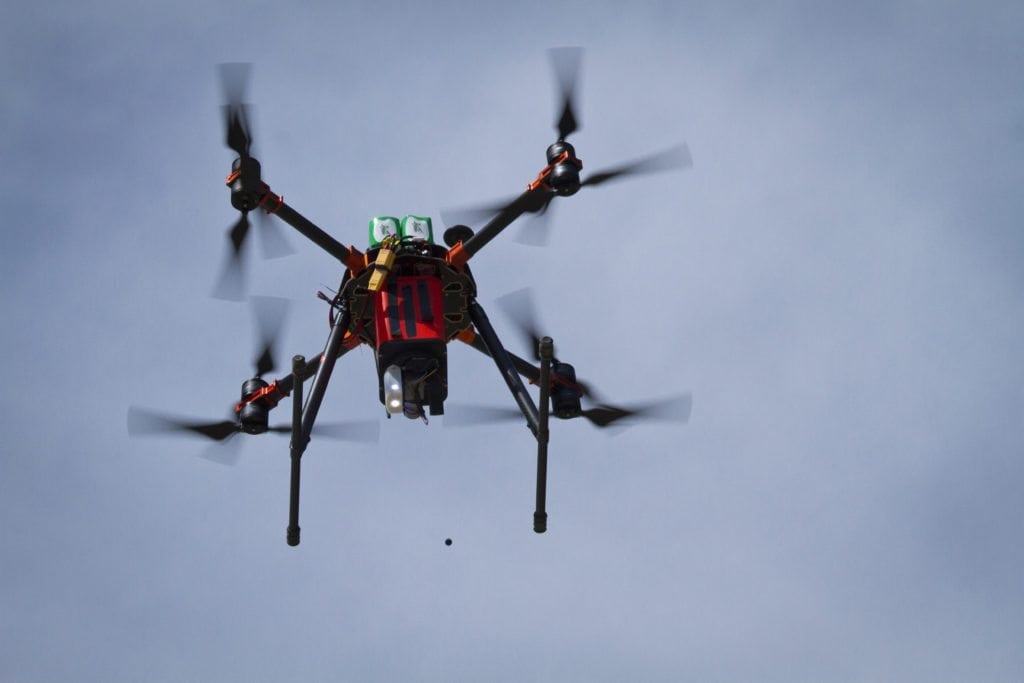 An aerial drone distributes plague vaccine pellets to prairie dog colony in Montana. (WWF/Conservation Media)