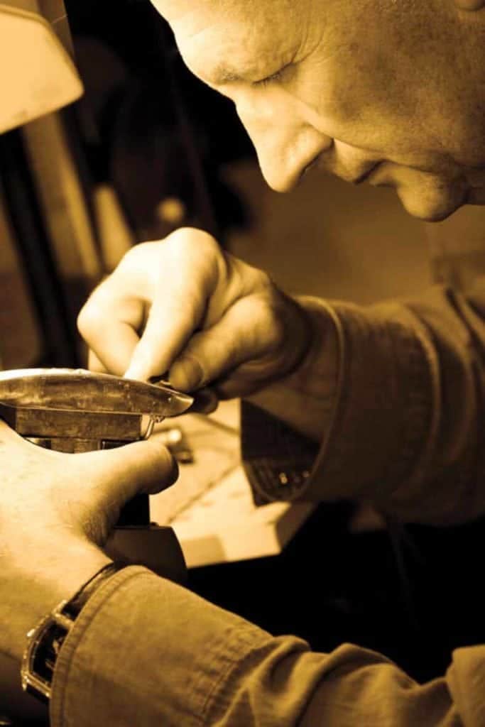 Close-up of silversmith Clint Orms at work