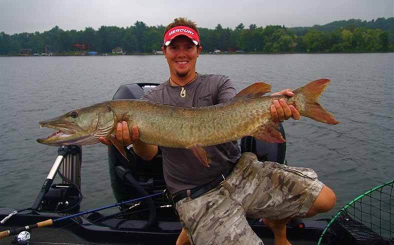 Fisherman showing his catch on Brainerd Lake, Minnesota