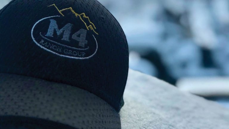 close-up shot of an M4 Ranch Group baseball cap.