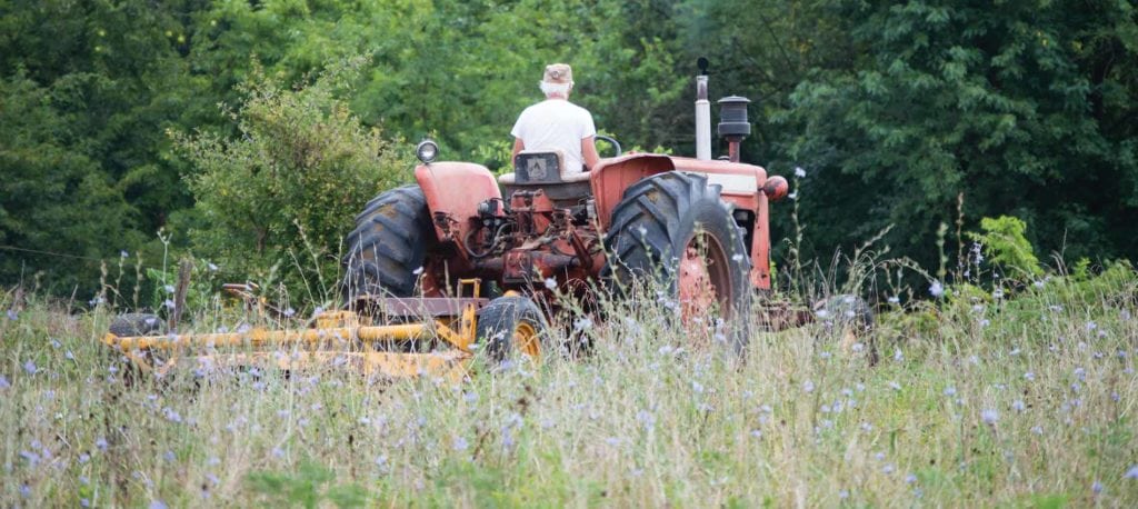 image of farmer on tractor in field