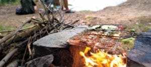 image of fisherman and campfire cooking
