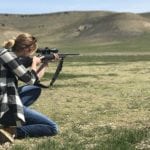 image of female hunter with rifle