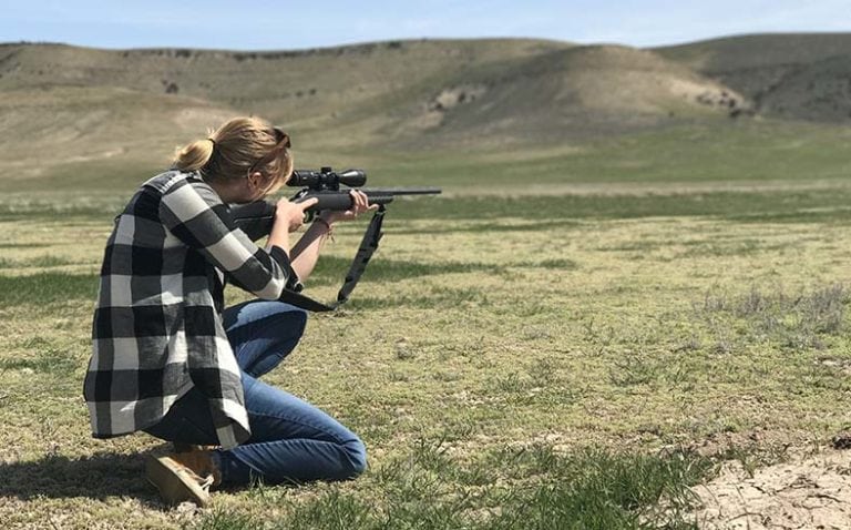 image of female hunter with rifle