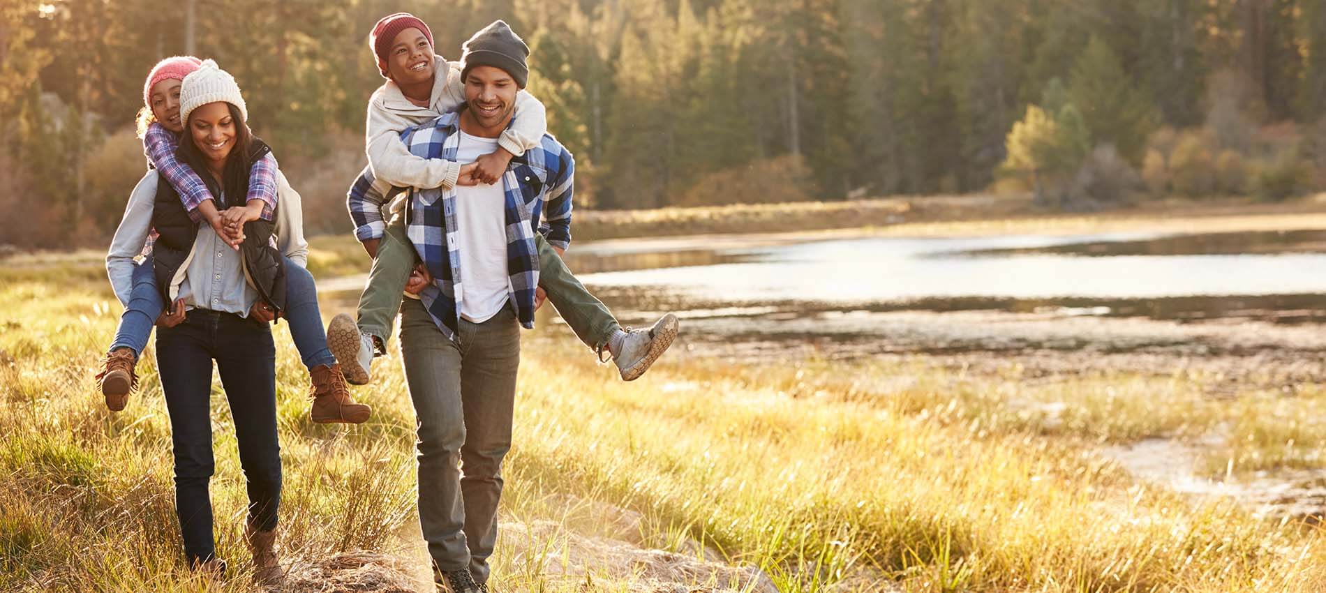 family enjoying hike by lake