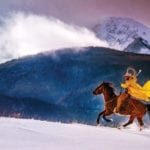 Chris Douglas - cowboy riding horse in snow