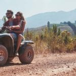 young couple riding quad bike