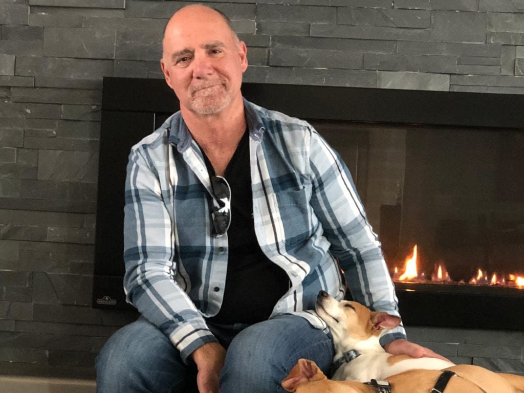 Dave with his grand-dogs Cleo and Tegan at his ranch house in Round Mountain, Texas.