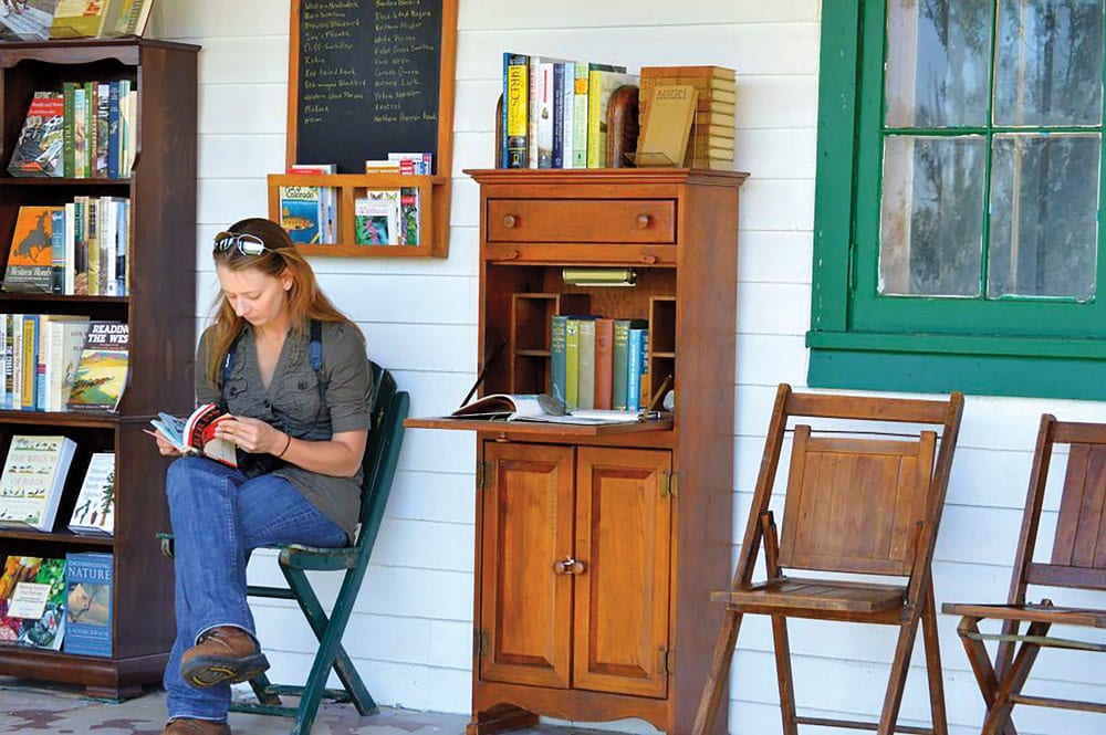 Woman reading a book at Rocky Mountain Land Library