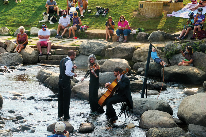 Tree-o makes their debut pop-up concert in the middle of the Blue River in Breckenridge, Colorado; Kevin Larkin (left), Karen Lauffer (center), Russick Smith (right).