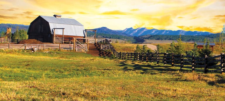 Western Heritage Consulting & Engineering; barn and fencing in front of mountains at sunset